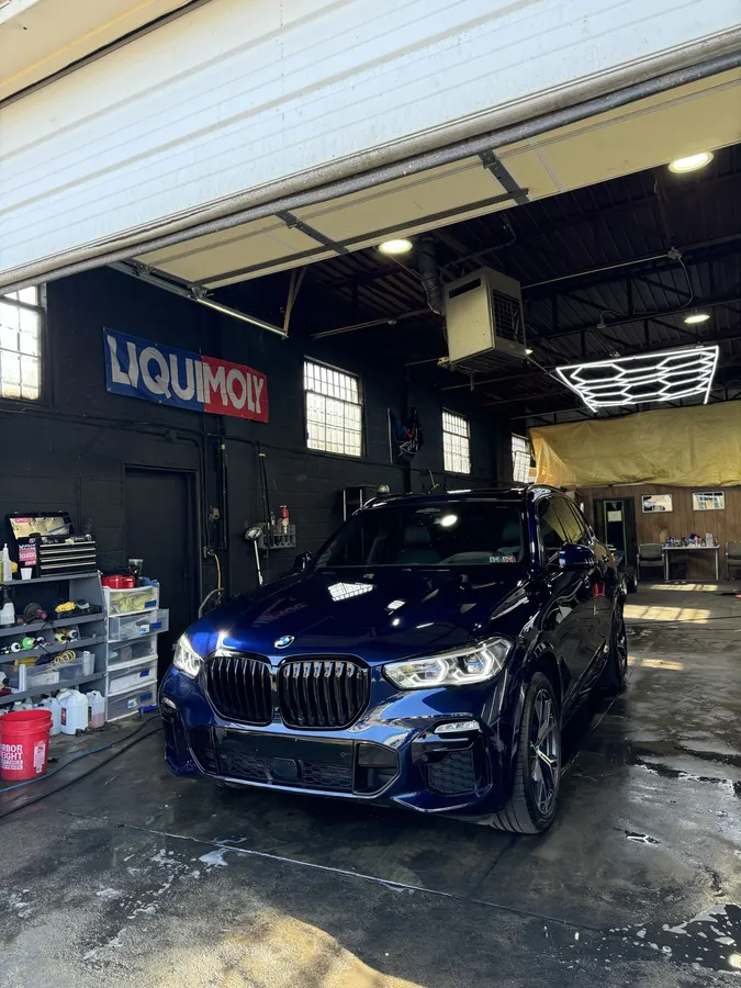 Black BMW inside the service bay
