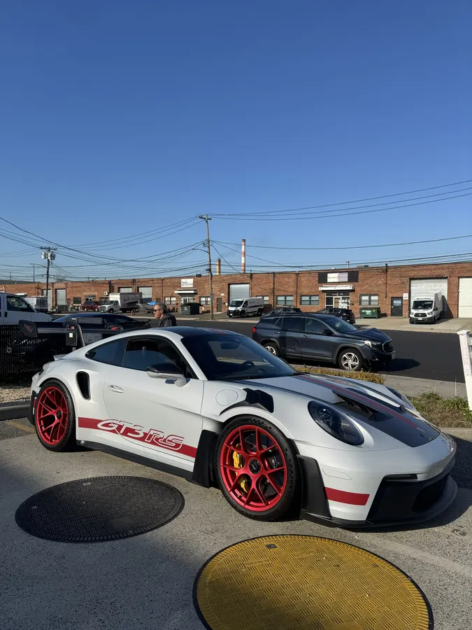 Porsche GT3 RS parked with red center-lock wheels