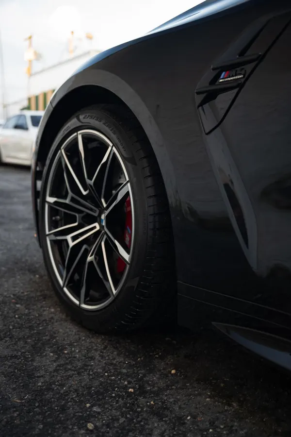 Close-up of a wheel and brake disc on a dark sports sedan